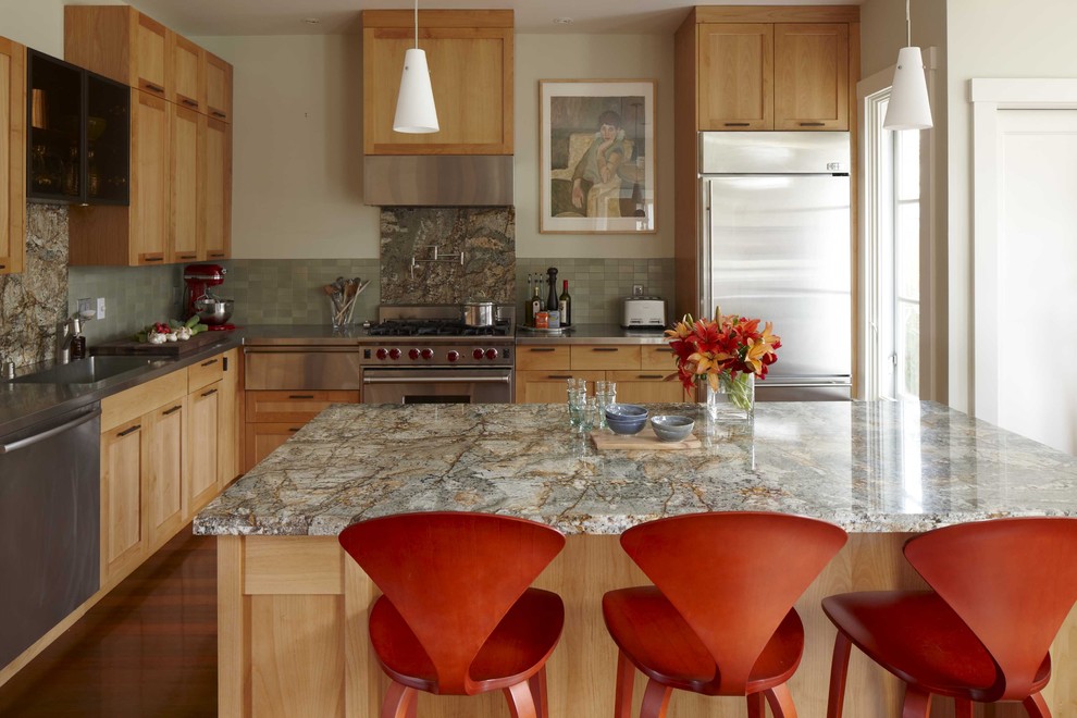 Example of a transitional l-shaped kitchen design in San Francisco with stainless steel appliances, an integrated sink, shaker cabinets, medium tone wood cabinets and green backsplash