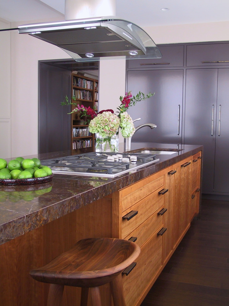 Medium sized traditional l-shaped open plan kitchen in New York with a submerged sink, flat-panel cabinets, medium wood cabinets, stainless steel appliances, quartz worktops, an island, brown floors and brown worktops.