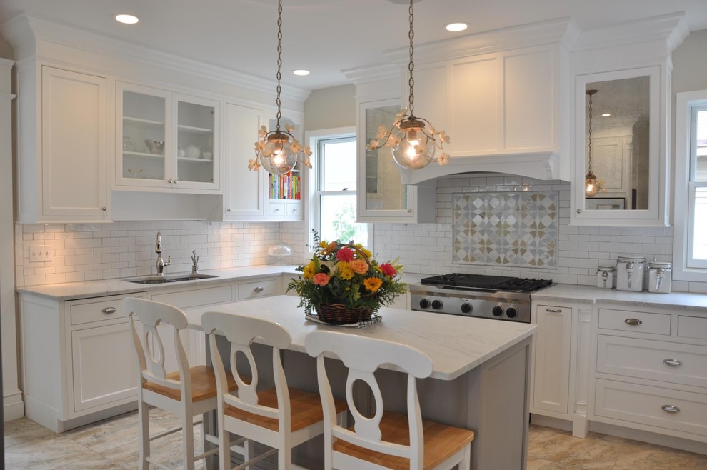 Traditional kitchen in New York with glass-front cabinets, white cabinets and white splashback.