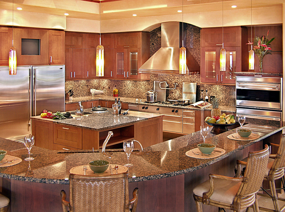 Huge trendy l-shaped travertine floor open concept kitchen photo in Hawaii with a double-bowl sink, shaker cabinets, medium tone wood cabinets, granite countertops, brown backsplash, stone slab backsplash, stainless steel appliances and two islands