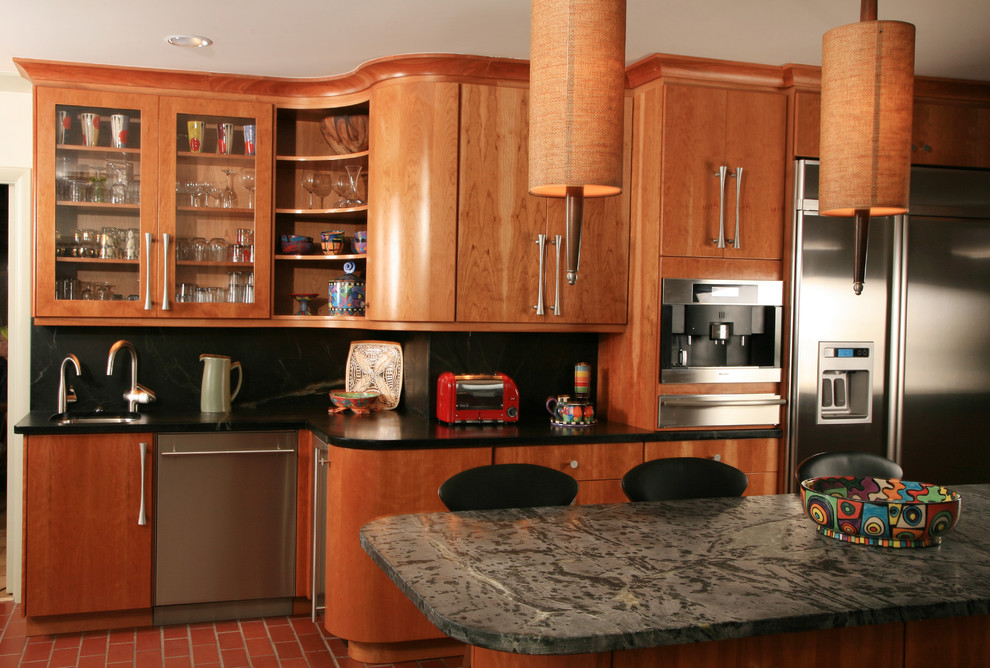 Photo of a modern kitchen in Other with a submerged sink, flat-panel cabinets, medium wood cabinets, black splashback and stainless steel appliances.
