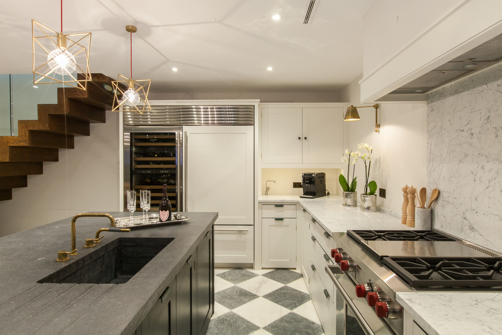 На фото: кухня среднего размера в стиле модернизм с монолитной мойкой, белыми фасадами, гранитной столешницей, белым фартуком и островом
