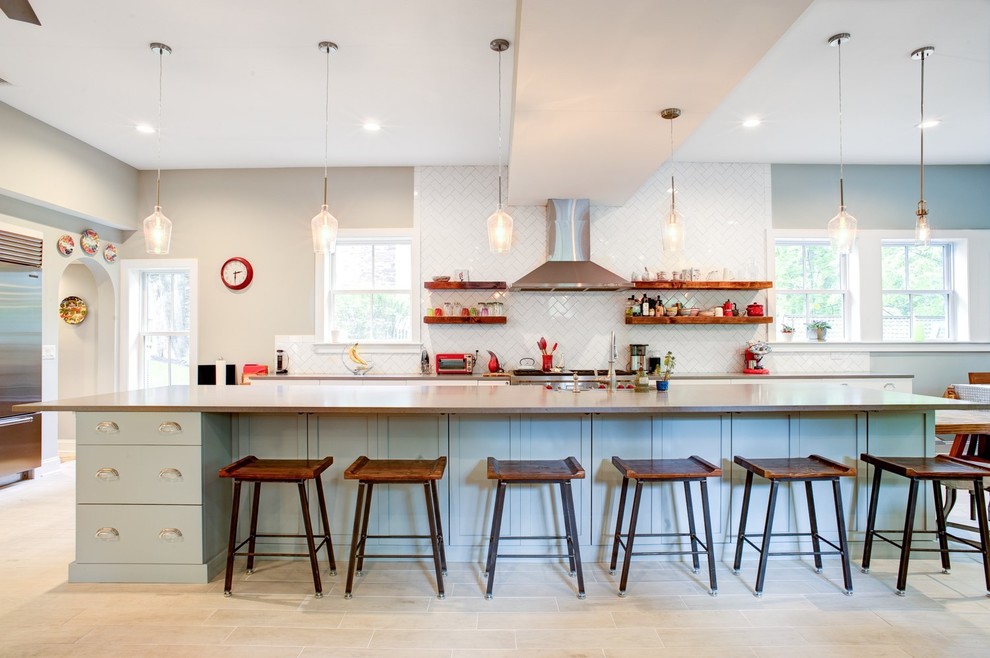 Large transitional galley light wood floor and beige floor open concept kitchen photo in Philadelphia with an undermount sink, shaker cabinets, white cabinets, quartz countertops, white backsplash, subway tile backsplash, stainless steel appliances and an island