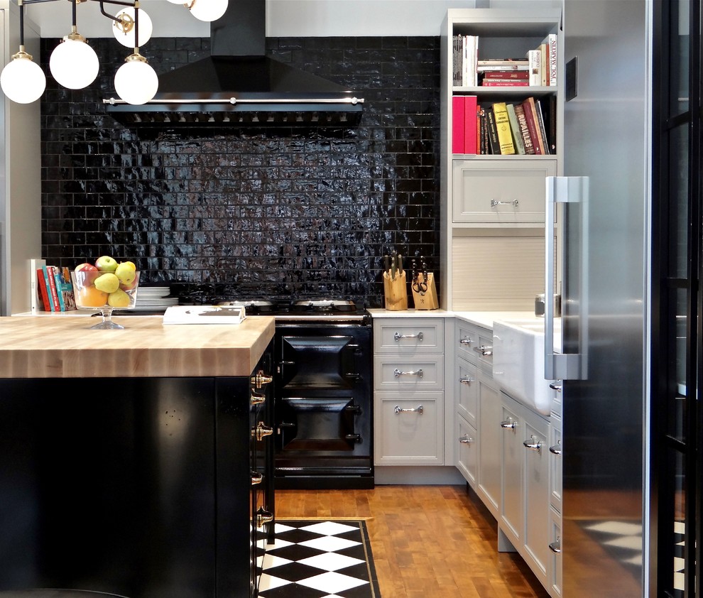 Example of a small transitional l-shaped medium tone wood floor kitchen design in Calgary with a farmhouse sink, marble countertops, black backsplash, ceramic backsplash, stainless steel appliances, an island, recessed-panel cabinets and white cabinets