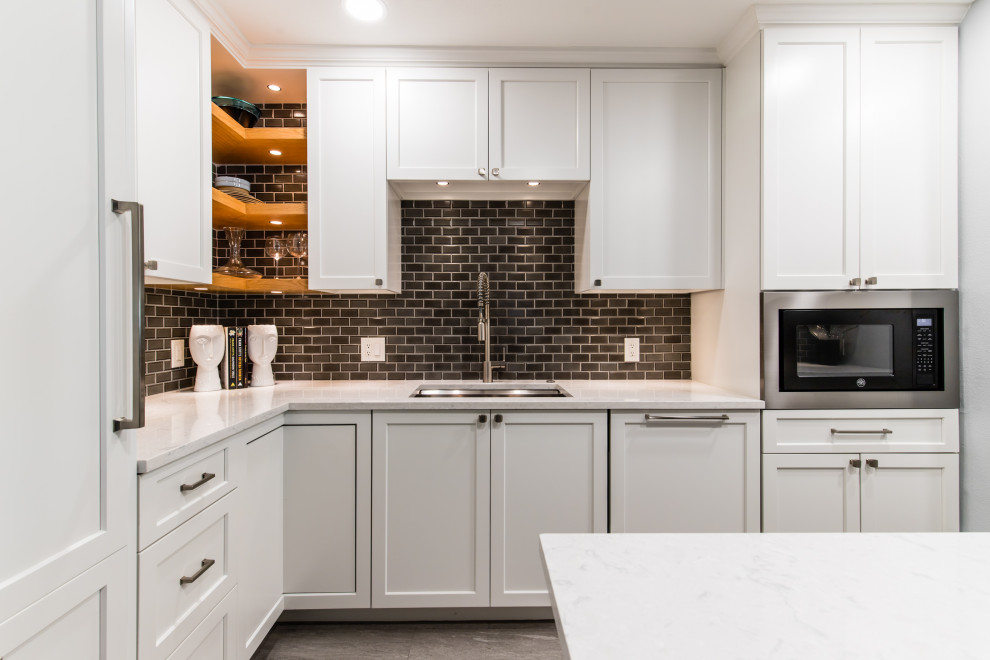 Small classic u-shaped kitchen/diner in Dallas with shaker cabinets, white cabinets, engineered stone countertops, brown splashback, porcelain splashback, stainless steel appliances, porcelain flooring, an island, multi-coloured floors and white worktops.