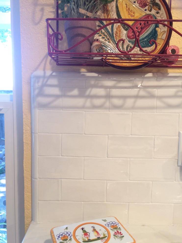 Elegant eat-in kitchen photo in Sacramento with white backsplash, ceramic backsplash and marble countertops