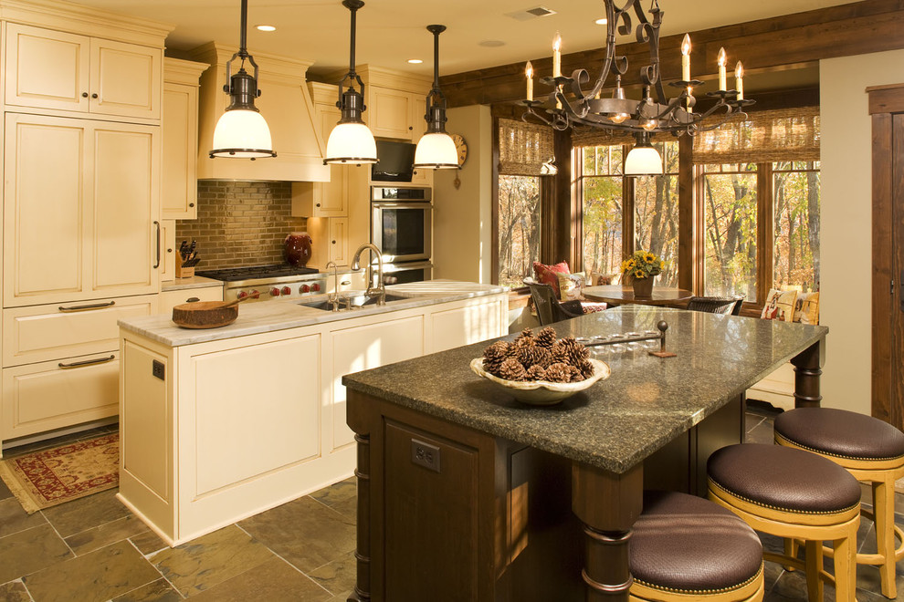 Elegant kitchen photo in Minneapolis with an undermount sink, raised-panel cabinets, beige cabinets, granite countertops and subway tile backsplash