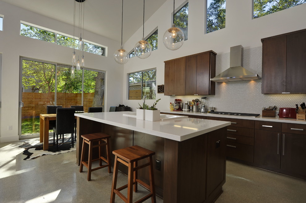 Example of a trendy kitchen design in Austin with flat-panel cabinets and mosaic tile backsplash