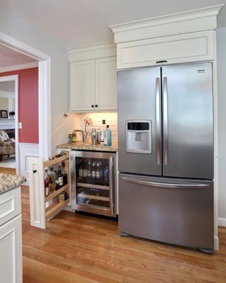 Inspiration for a traditional u-shaped kitchen/diner in Boston with a submerged sink, white cabinets, granite worktops, white splashback, ceramic splashback and stainless steel appliances.