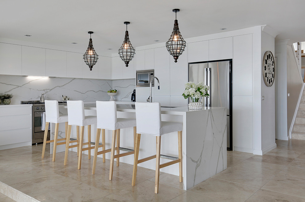 Inspiration for a medium sized modern kitchen in Sydney with flat-panel cabinets, white cabinets, marble worktops, white splashback, marble splashback, stainless steel appliances, ceramic flooring and brown floors.