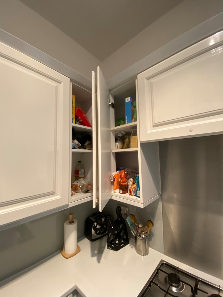 Exempel på ett avskilt, litet modernt vit vitt u-kök, med en undermonterad diskho, skåp i shakerstil, grå skåp, bänkskiva i kvartsit, vitt stänkskydd, svarta vitvaror, ljust trägolv och grått golv