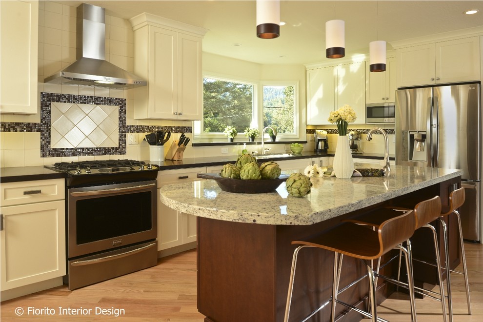 Example of a mid-sized transitional l-shaped light wood floor open concept kitchen design in San Francisco with a double-bowl sink, shaker cabinets, white cabinets, granite countertops, white backsplash, porcelain backsplash, stainless steel appliances and an island