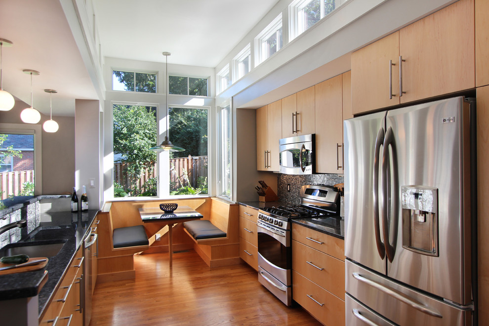 Eat-in kitchen - contemporary galley eat-in kitchen idea in DC Metro with stainless steel appliances, a single-bowl sink, flat-panel cabinets and light wood cabinets