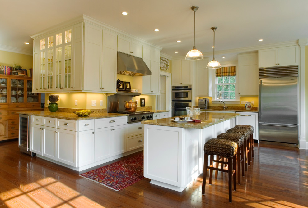 Inspiration for a mid-sized timeless l-shaped light wood floor eat-in kitchen remodel in Other with recessed-panel cabinets, white cabinets, granite countertops, stainless steel appliances and an island