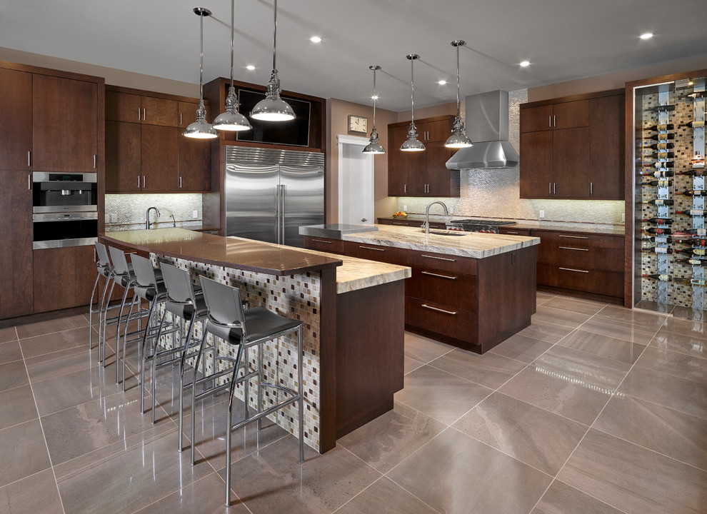 Design ideas for a large contemporary kitchen in Edmonton with a submerged sink, flat-panel cabinets, dark wood cabinets, granite worktops, metallic splashback, mosaic tiled splashback, stainless steel appliances, porcelain flooring, multiple islands and grey floors.