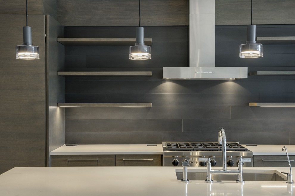 Photo of a medium sized contemporary l-shaped open plan kitchen in Minneapolis with a submerged sink, flat-panel cabinets, light wood cabinets, engineered stone countertops, grey splashback, wood splashback, stainless steel appliances, painted wood flooring, an island and grey floors.