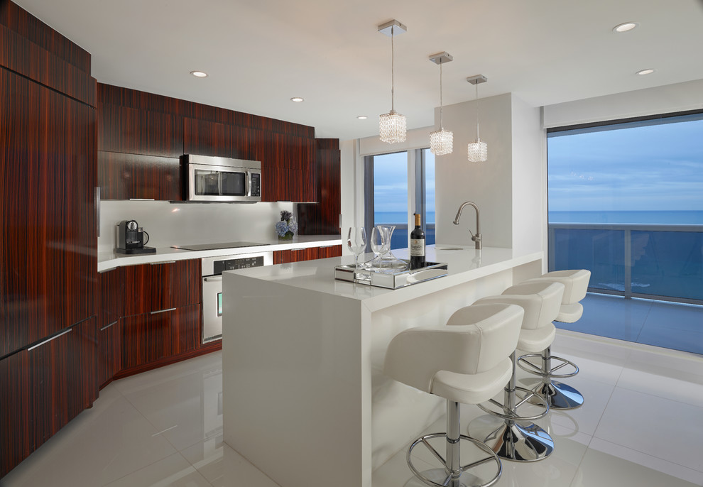 Design ideas for a contemporary galley kitchen in Miami with a submerged sink, stainless steel appliances and an island.