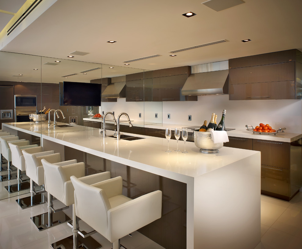 This is an example of a contemporary galley kitchen in Miami with a double-bowl sink, flat-panel cabinets, brown cabinets and an island.