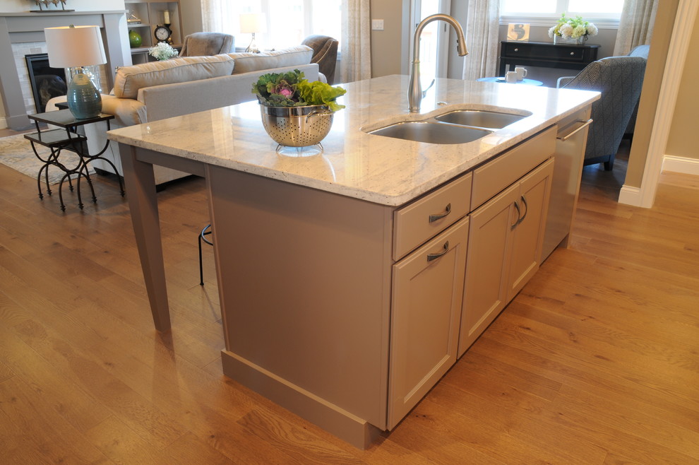 Example of a mid-sized arts and crafts l-shaped light wood floor open concept kitchen design in Other with a drop-in sink, stainless steel appliances and an island