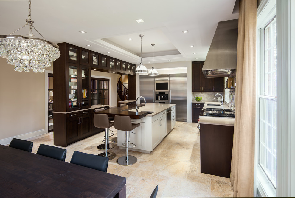 This is an example of a contemporary l-shaped kitchen/diner in Ottawa with shaker cabinets, dark wood cabinets, stainless steel appliances and an island.