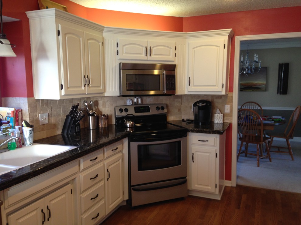 Mid-sized elegant galley eat-in kitchen photo in Kansas City with raised-panel cabinets and white cabinets