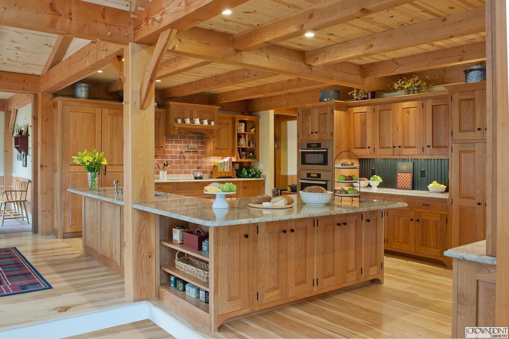 Photo of a large rustic u-shaped kitchen in DC Metro with raised-panel cabinets and an island.