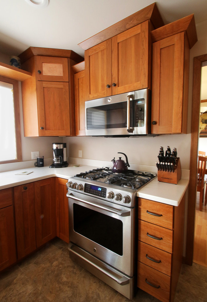 Example of an arts and crafts kitchen design in Other with recessed-panel cabinets