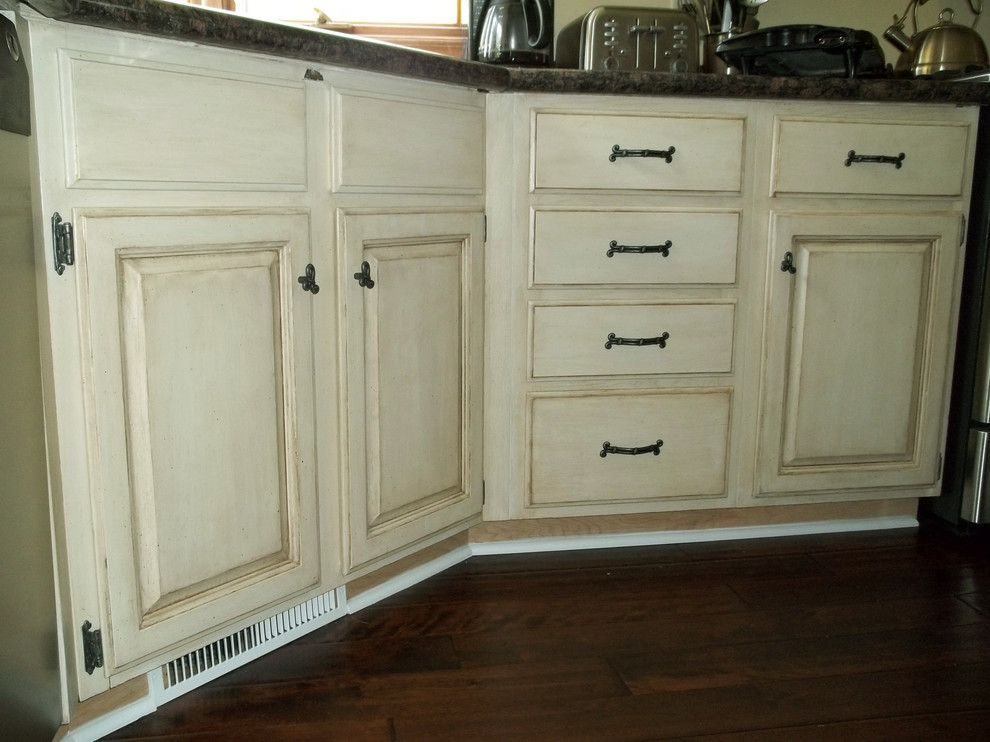 This is an example of a large shabby-chic style galley kitchen pantry in Other with a double-bowl sink, recessed-panel cabinets, medium wood cabinets, granite worktops, black appliances, dark hardwood flooring and an island.