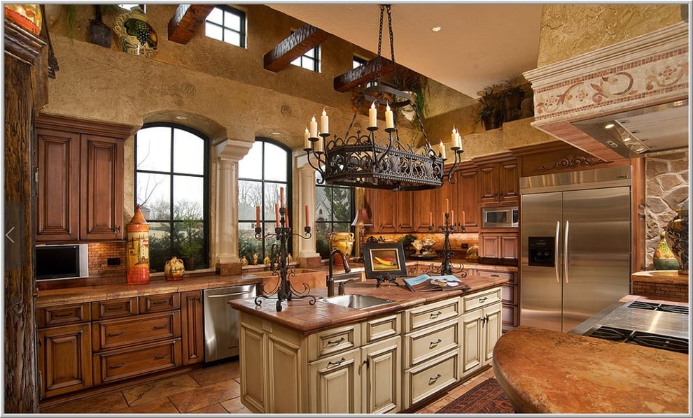 Kitchen - large mediterranean u-shaped travertine floor kitchen idea in New York with a farmhouse sink, recessed-panel cabinets, dark wood cabinets, granite countertops, brown backsplash, glass tile backsplash, stainless steel appliances and two islands