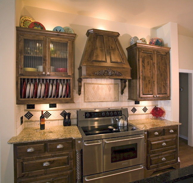This is an example of a medium sized traditional single-wall kitchen in Oklahoma City with a double-bowl sink, raised-panel cabinets, granite worktops, beige splashback, stainless steel appliances, medium hardwood flooring, an island and brown floors.