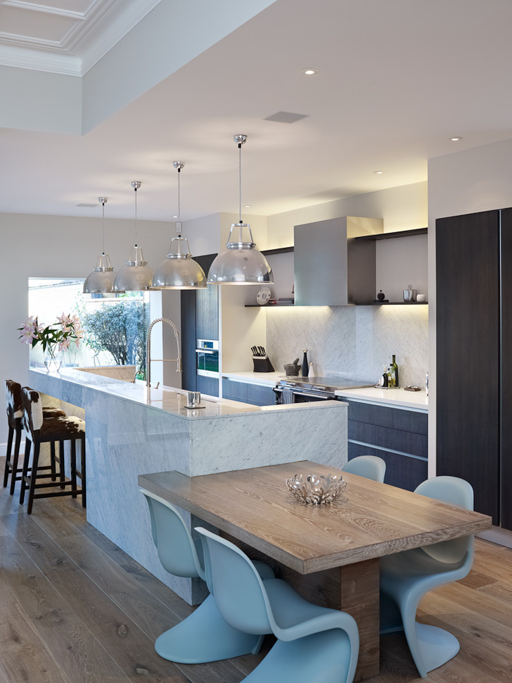 This is an example of a contemporary kitchen/diner in London with an island.