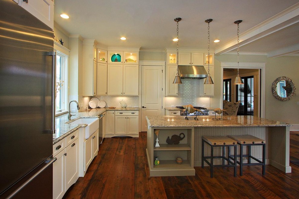 Large l-shaped medium tone wood floor open concept kitchen photo in Atlanta with a farmhouse sink, recessed-panel cabinets, beige cabinets, granite countertops, white backsplash, subway tile backsplash, stainless steel appliances and an island