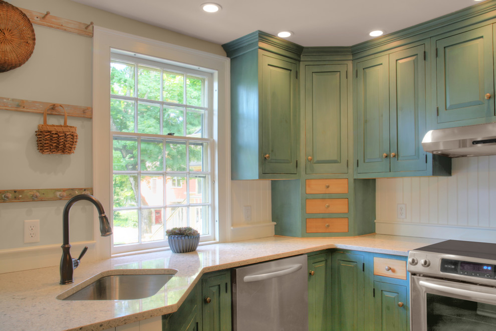 Urige Küche mit Granit-Arbeitsplatte, Waschbecken, profilierten Schrankfronten, grünen Schränken und Küchengeräten aus Edelstahl in Bridgeport