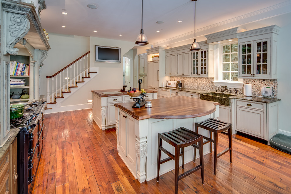 Huge farmhouse u-shaped medium tone wood floor eat-in kitchen photo in DC Metro with a farmhouse sink, recessed-panel cabinets, distressed cabinets, wood countertops, multicolored backsplash, porcelain backsplash, colored appliances and two islands