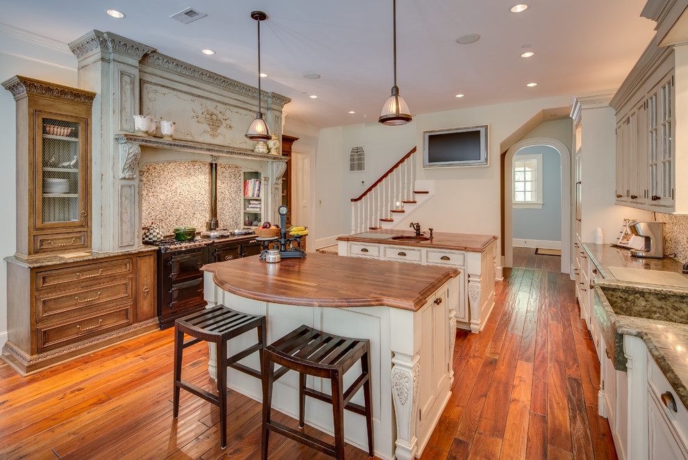 Huge cottage u-shaped medium tone wood floor eat-in kitchen photo in DC Metro with a farmhouse sink, recessed-panel cabinets, distressed cabinets, wood countertops, multicolored backsplash, porcelain backsplash, colored appliances and two islands