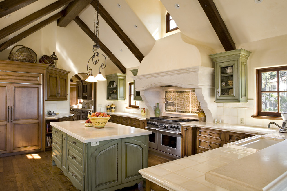 Inspiration for a mediterranean kitchen remodel in Other with an undermount sink, raised-panel cabinets, green cabinets, multicolored backsplash and paneled appliances
