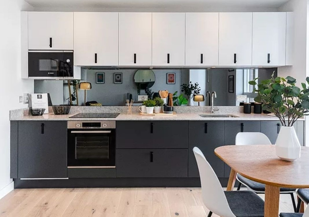 Trendy single-wall open concept kitchen photo with no island