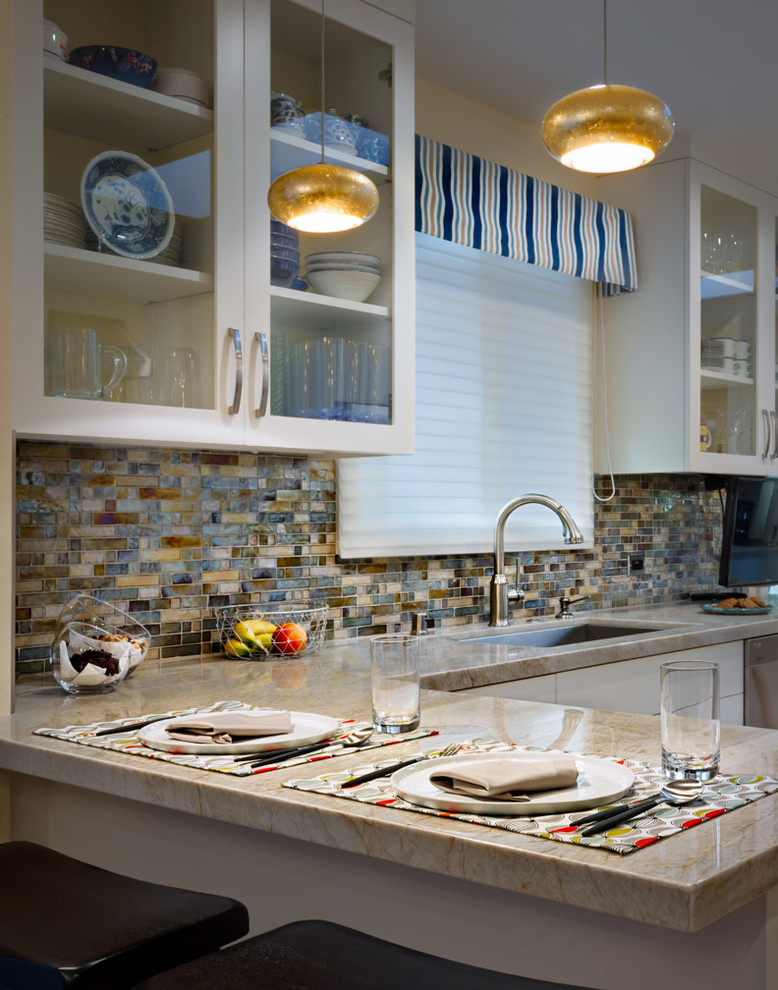 Inspiration for a mid-sized 1950s l-shaped light wood floor enclosed kitchen remodel in San Francisco with a drop-in sink, glass-front cabinets, white cabinets, marble countertops, multicolored backsplash, mosaic tile backsplash, stainless steel appliances and an island