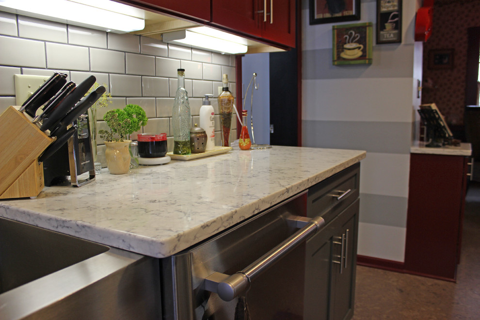 Example of a small arts and crafts galley cork floor and brown floor eat-in kitchen design in Other with a farmhouse sink, quartzite countertops, gray backsplash, subway tile backsplash, stainless steel appliances, no island, shaker cabinets and red cabinets
