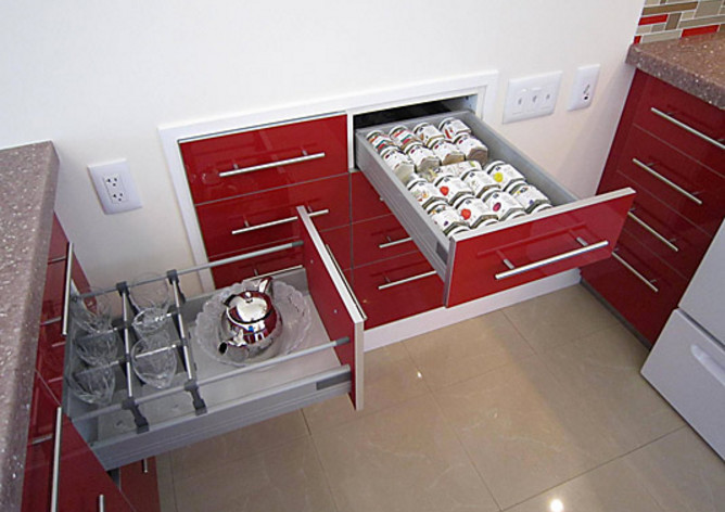 Inspiration for a medium sized contemporary l-shaped open plan kitchen in Vancouver with a double-bowl sink, flat-panel cabinets, red cabinets, laminate countertops, multi-coloured splashback, mosaic tiled splashback, white appliances, concrete flooring and a breakfast bar.