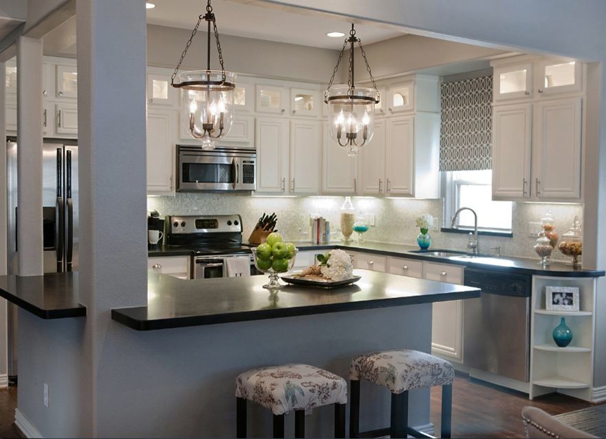 Eat-in kitchen - traditional l-shaped eat-in kitchen idea in Nashville with an undermount sink, flat-panel cabinets, white cabinets, granite countertops, blue backsplash and stainless steel appliances