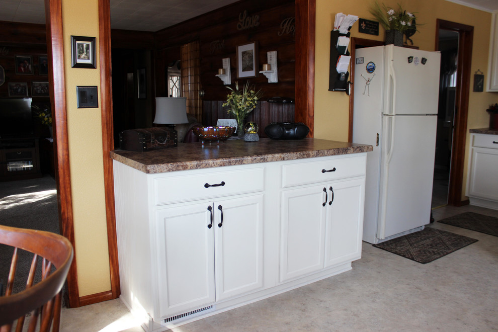 Photo of a medium sized traditional u-shaped kitchen/diner in Other with a double-bowl sink, flat-panel cabinets, white cabinets, laminate countertops, white appliances, no island and white floors.