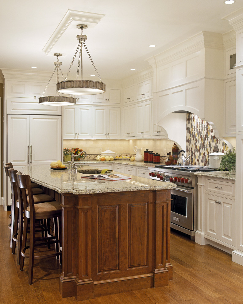 Large elegant u-shaped medium tone wood floor and brown floor eat-in kitchen photo in Boston with an undermount sink, raised-panel cabinets, medium tone wood cabinets, granite countertops, black backsplash, subway tile backsplash, paneled appliances and an island