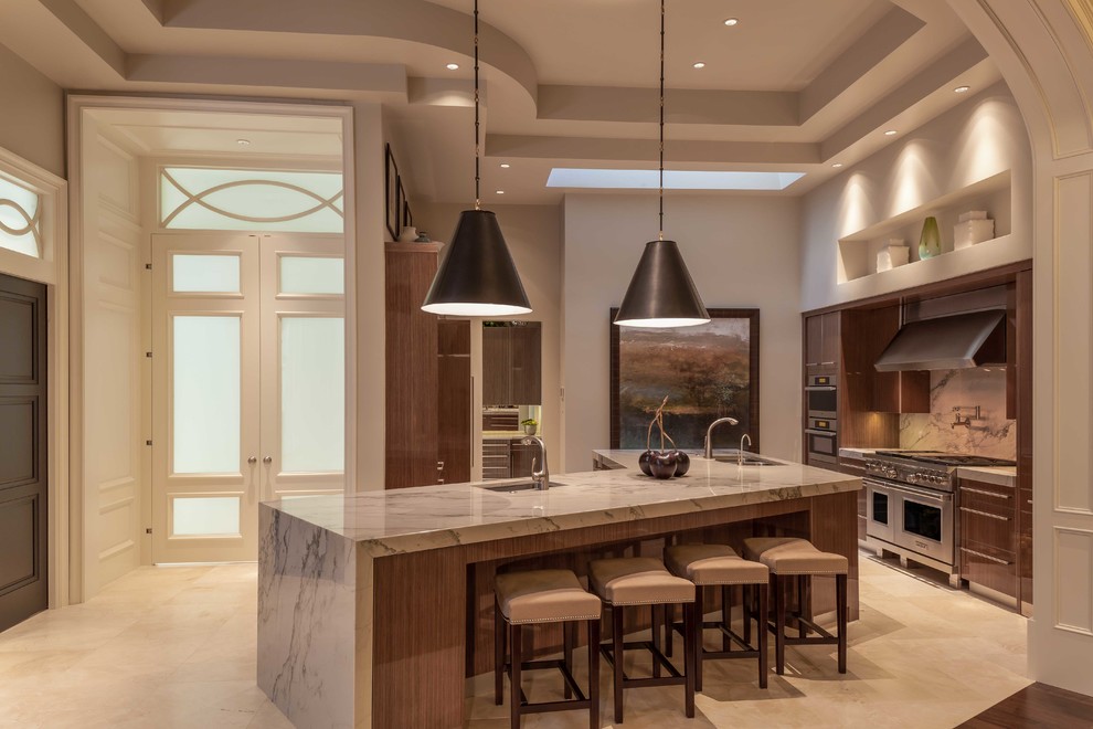 This is an example of a large l-shaped kitchen/diner in Miami with an integrated sink, flat-panel cabinets, medium wood cabinets, marble worktops, stone tiled splashback, stainless steel appliances, marble flooring and an island.