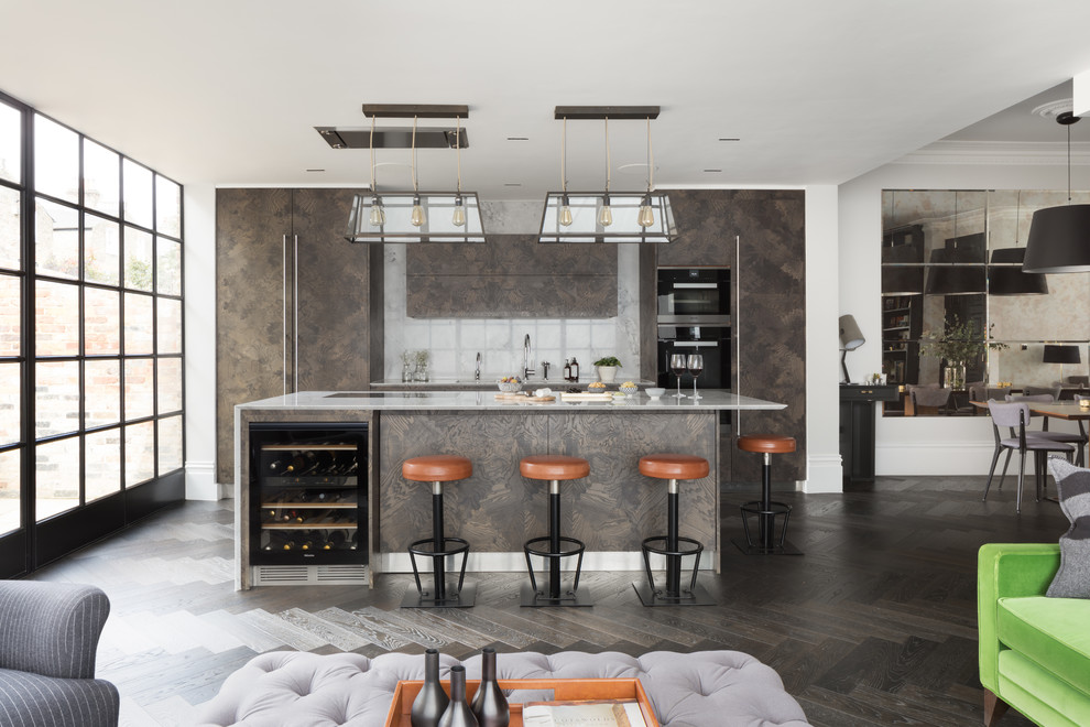 Photo of a contemporary open plan kitchen in London with flat-panel cabinets, brown cabinets, grey splashback, black appliances, dark hardwood flooring, an island, brown floors and grey worktops.