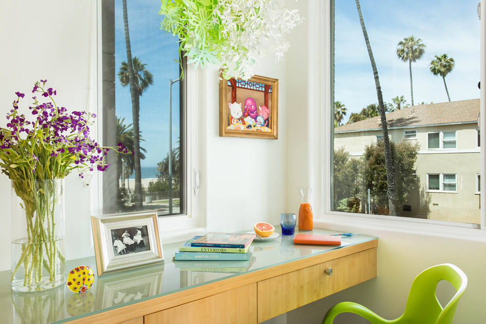 Example of a mid-sized beach style u-shaped porcelain tile and gray floor eat-in kitchen design in Los Angeles with a double-bowl sink, flat-panel cabinets, light wood cabinets, granite countertops, blue backsplash, glass sheet backsplash, stainless steel appliances and an island