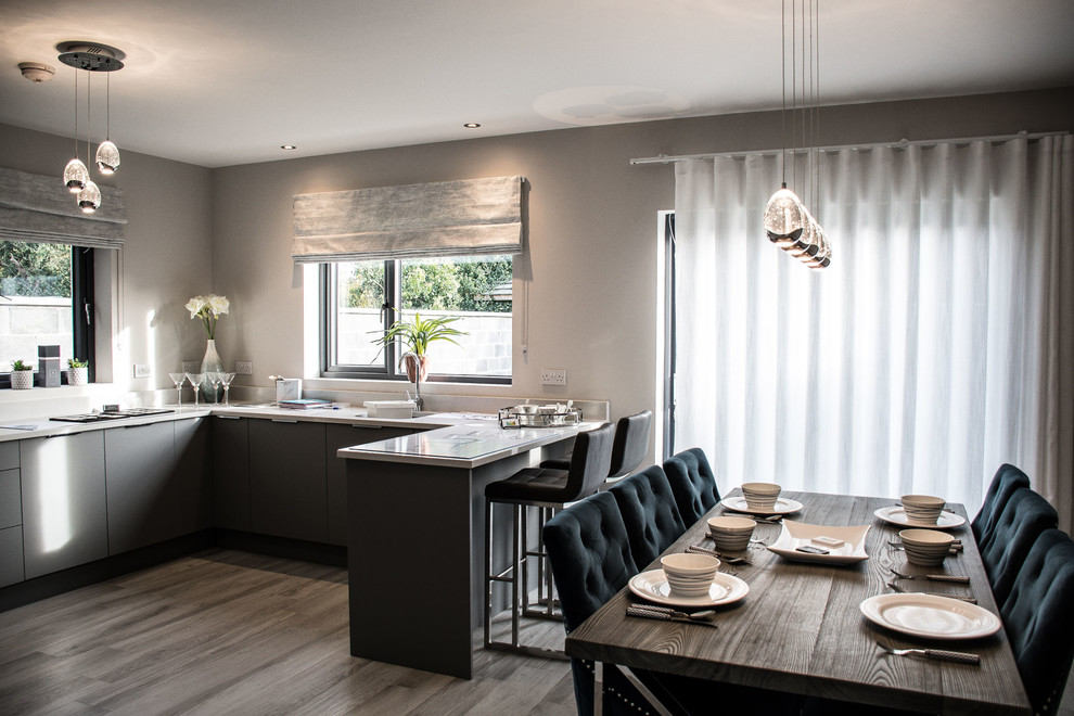 Photo of a medium sized modern l-shaped kitchen/diner in Other with a built-in sink, flat-panel cabinets, grey cabinets, marble worktops, stainless steel appliances, an island and white worktops.