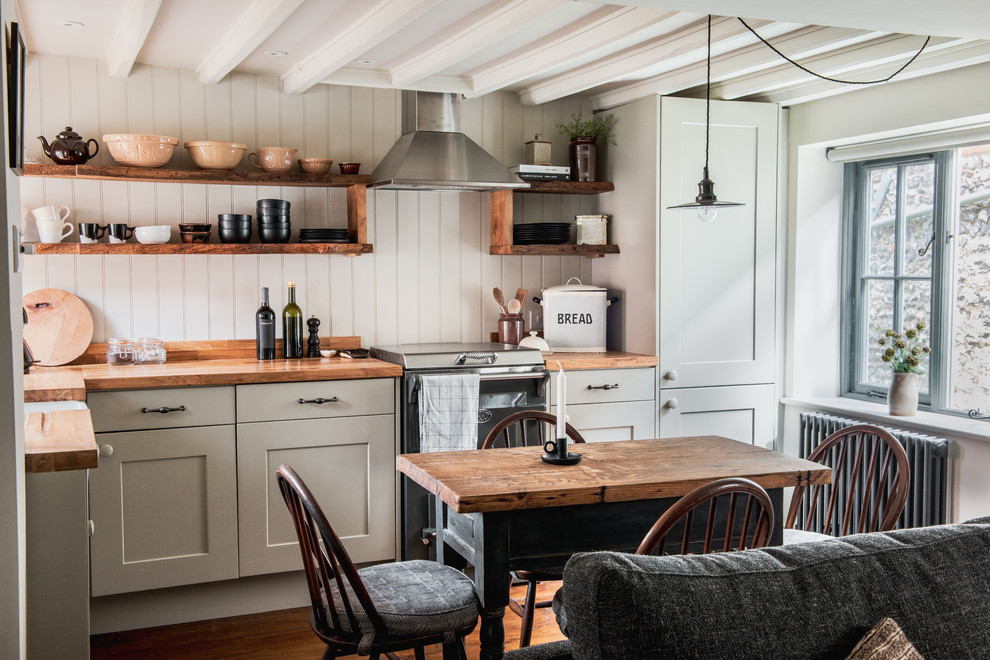 Design ideas for a small rural l-shaped kitchen/diner in Other with a belfast sink, wood worktops, medium hardwood flooring, shaker cabinets, brown floors, brown worktops and exposed beams.