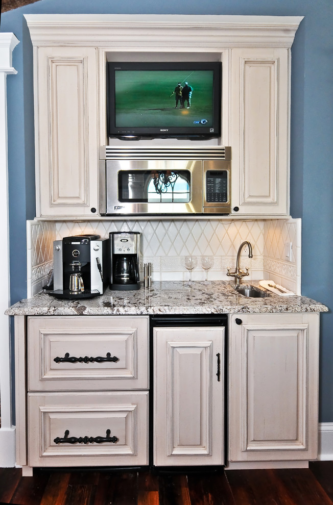 Example of a tuscan kitchen design in Other with granite countertops, raised-panel cabinets and beige cabinets