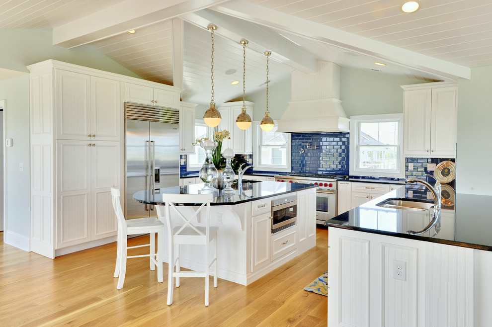 Inspiration for a nautical u-shaped kitchen in Other with stainless steel appliances, a double-bowl sink, recessed-panel cabinets, white cabinets, granite worktops, blue splashback and metro tiled splashback.